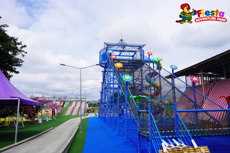A blue steel play tower with spiral slides on a purple surface