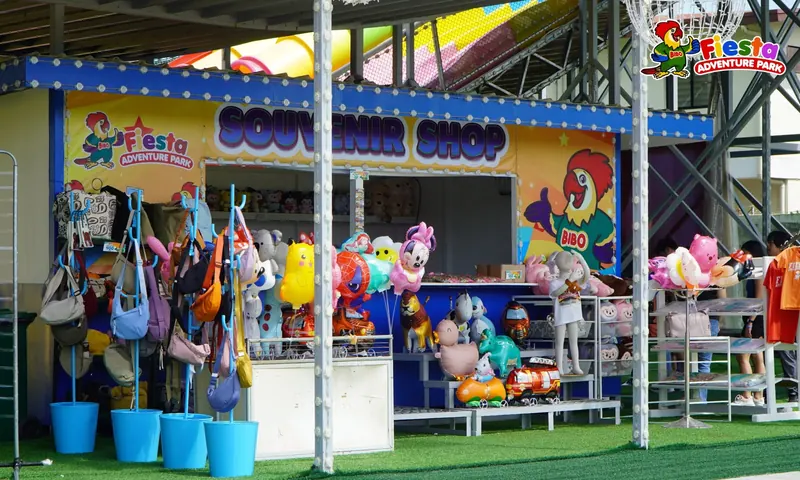 A prize booth filled with plush toys under a striped awning