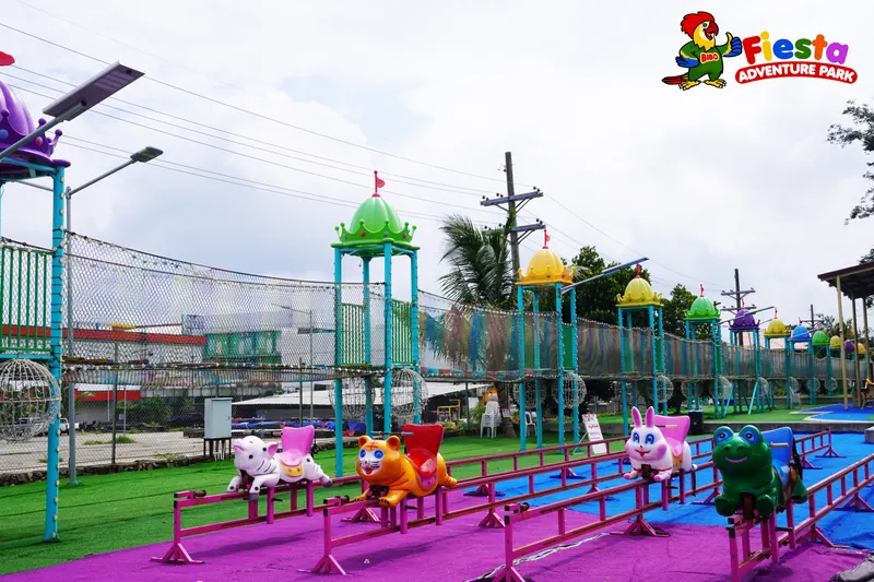 Small animal rides and play equipment on a purple surface