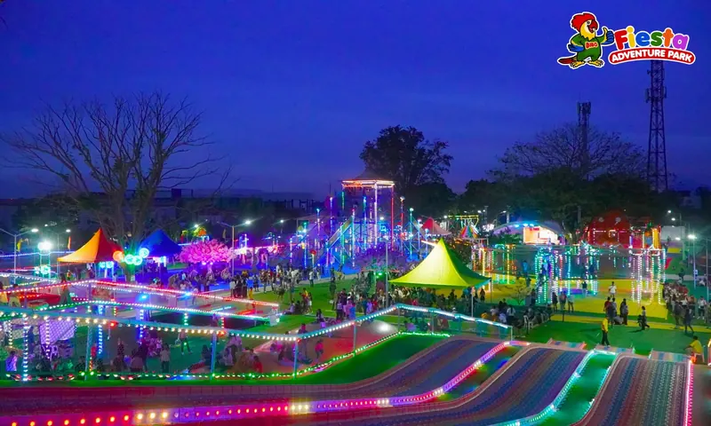 The rainbow slide hill and playgrounds lit up in colour after dark