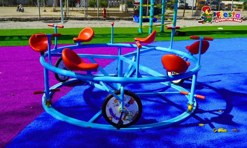 A blue and orange merry-go-round on a purple surface