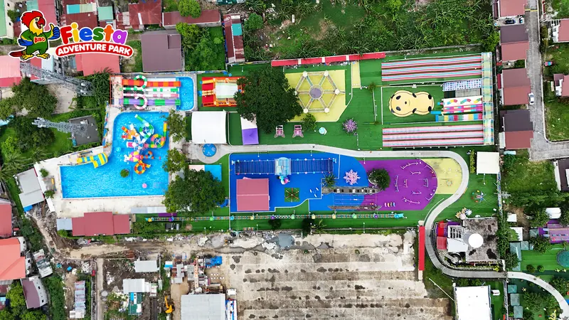 Drone view of the entire park showing the waterpark pools, rainbow slides, playgrounds and rides