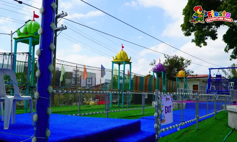 A row of blue and green play towers seen across the park