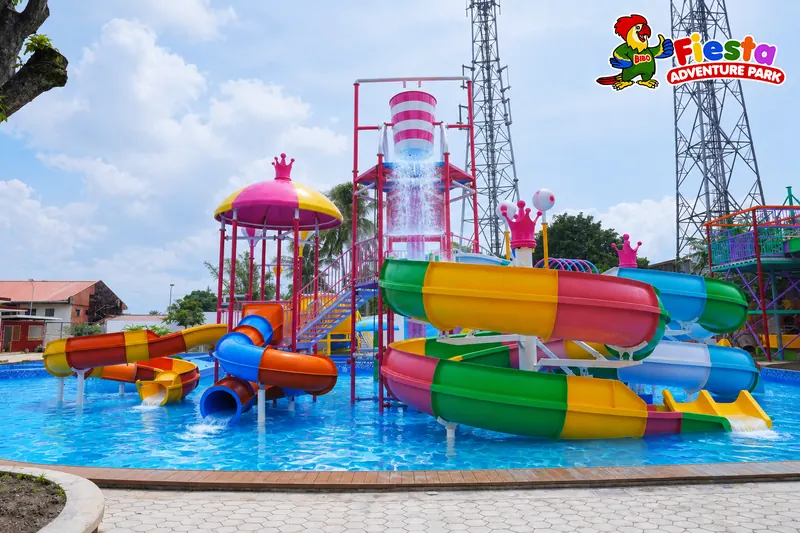 Striped kiddie slides and a play structure in the shallow pool