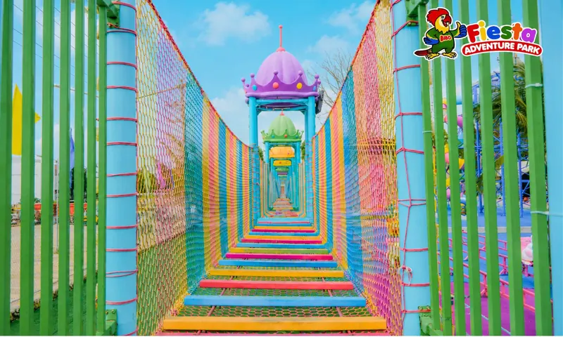 A long walkway framed by rainbow-coloured arches