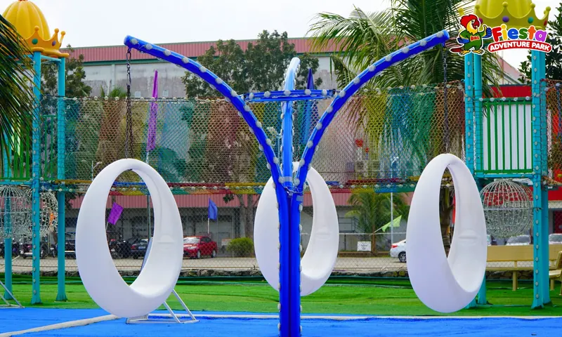 Large white rope loops for climbing through, set on a play mat