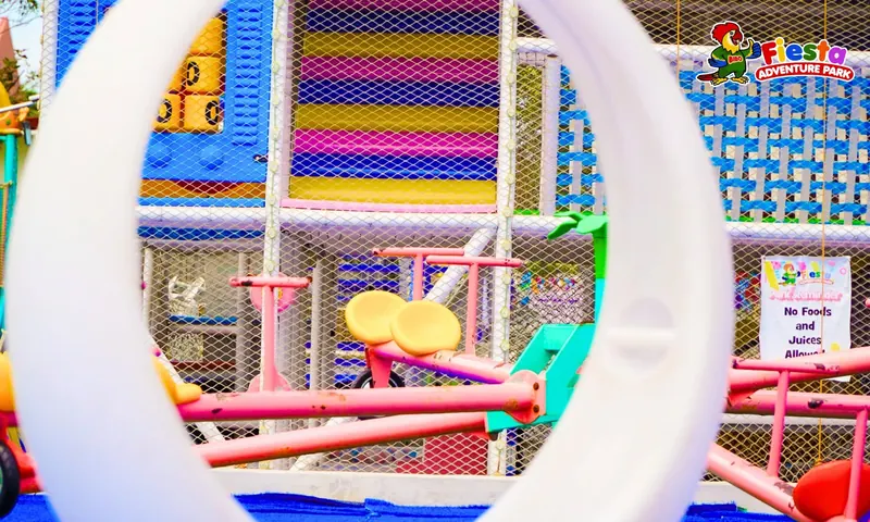 A white rope ring maze inside the netted play area