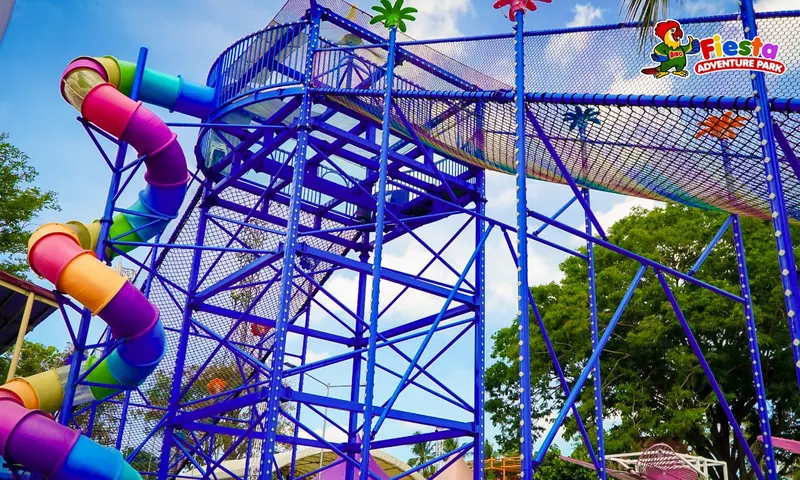 A spiral tube slide winding through a blue steel frame